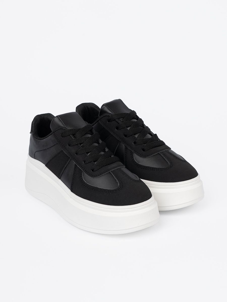 Klassische schwarze Sneakers mit dicker Sohle