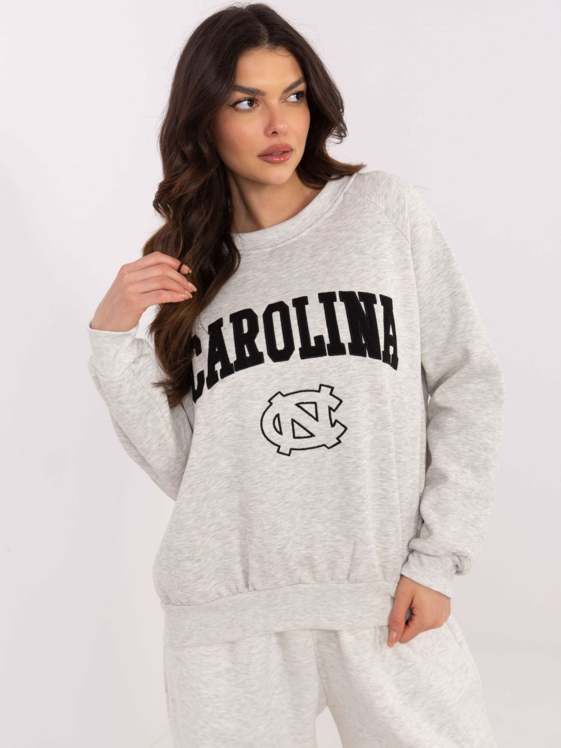 Grauer Pullover mit Applikationen und Stickerei