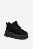 Schwarze Snowboots mit Lammfell auf Plateausohle