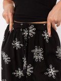 Schwarze Palazzo-Hose mit Gürtel und Print